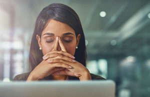 Woman looking fed up at her computer