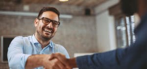 Happy man shaking hands with someone