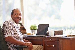 image of man at office desk smiling