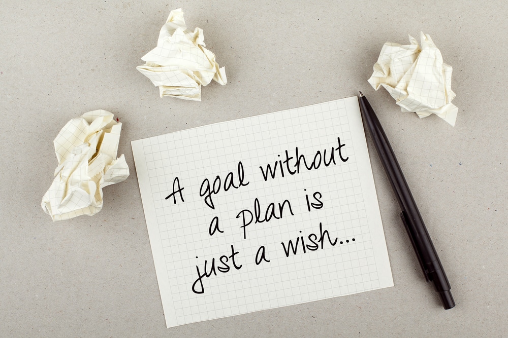 photo of pen and paper with A Goal Without a Plan is Just a Wish text