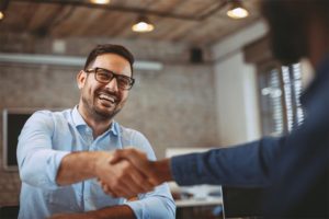 A smiling man finds joy in his working life again as he shakes hands with his TES career transition specialist.