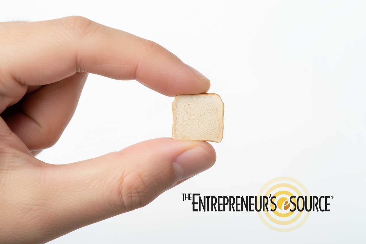 holding miniature slice of bread