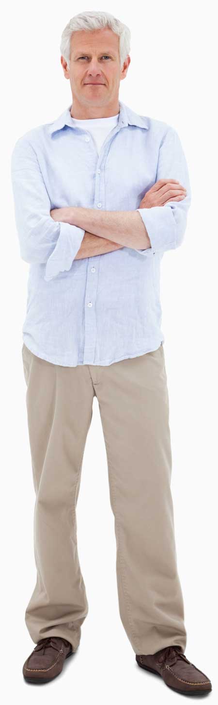 Older man with gray hair standing with arms crossed, wearing a light blue shirt and khaki pants.