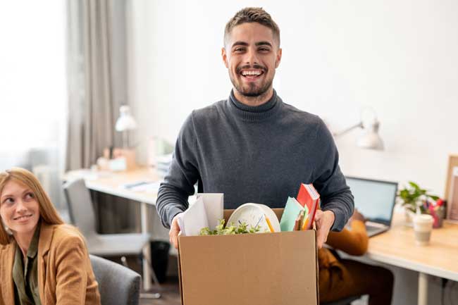young-cheerful-employee-holding-box-650px