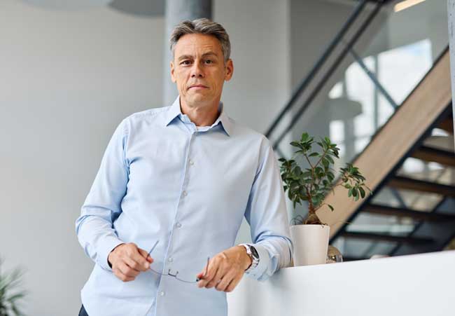 confident-man-with-gray-hair-in-office-environment