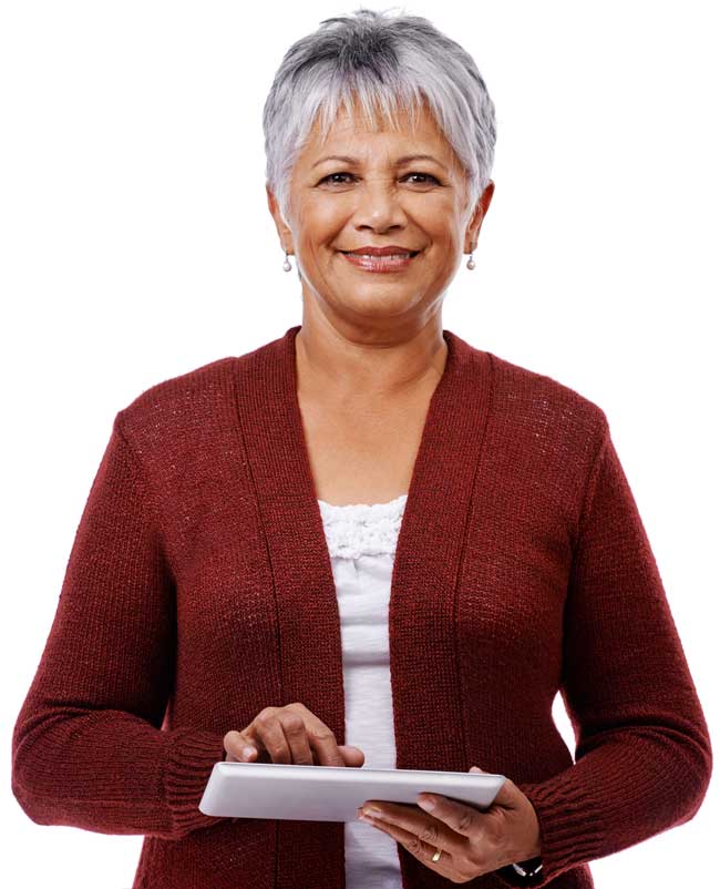 Smiling older woman with short gray hair wearing a burgundy cardigan and holding a tablet.
