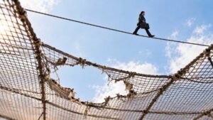 Businessman-Crossing-a-Torn-Safety-Net