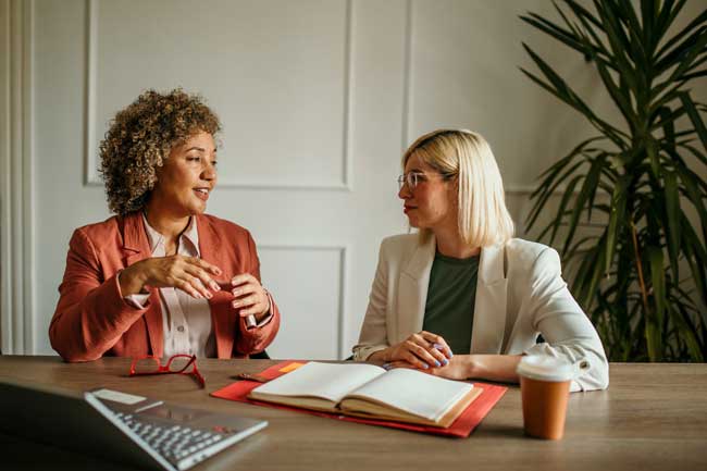 businesswomen-discussing-project-details