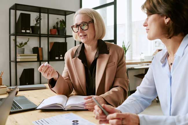 professional-women-discussing-business-at-desk