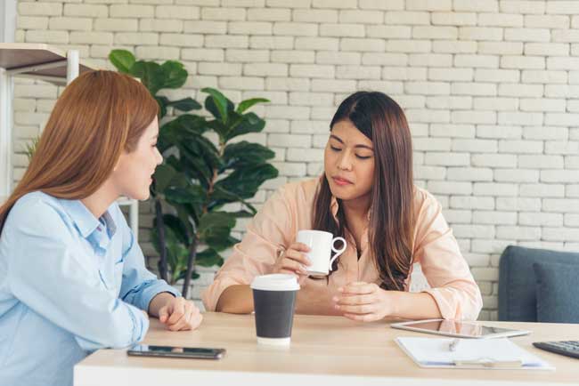 women-discussing-business-over-coffee